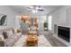 Cozy living room features neutral colors, a fireplace, and an open layout leading to the kitchen at 2191 Phillips Rd, Lithonia, GA 30058
