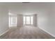 Bright living room featuring new carpeting, modern paint, and lots of windows at 2191 Phillips Rd, Lithonia, GA 30058