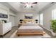 Calm main bedroom with tray ceilings, stylish furnishings, and large windows at 2191 Phillips Rd, Lithonia, GA 30058