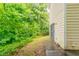 Lush side yard with mature landscaping adjacent to the home's exterior at 2191 Phillips Rd, Lithonia, GA 30058