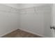 A view of a walk-in closet with white wire shelving, carpeted floor, and white walls at 2191 Phillips Rd, Lithonia, GA 30058