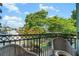 Balcony featuring wicker chairs and a scenic street view with mature trees at 3235 Roswell Ne Rd # 402, Atlanta, GA 30305
