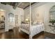 Serene bedroom features a canopy bed, hardwood floors, and mirrors with access to the bathroom at 3235 Roswell Ne Rd # 402, Atlanta, GA 30305