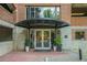 The building entrance features a covered walkway with plants and double doors at 3235 Roswell Ne Rd # 402, Atlanta, GA 30305