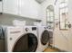 Bright laundry room with white cabinets and a side-by-side washer and dryer at 3235 Roswell Ne Rd # 402, Atlanta, GA 30305