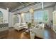 Beautifully designed living room featuring hardwood floors, white sofas, and unique decor throughout the space at 3235 Roswell Ne Rd # 402, Atlanta, GA 30305