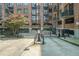 View of a parking garage entrance for a brick building with multiple balconies at 3235 Roswell Ne Rd # 402, Atlanta, GA 30305