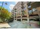 Exterior view of a parking garage for a brick building with multiple balconies at 3235 Roswell Ne Rd # 402, Atlanta, GA 30305