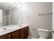 Bathroom featuring double sink vanity with dark wood cabinets, large mirror and shower/tub combo at 2482 Brittany Park Ln, Ellenwood, GA 30294