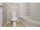 Bright bathroom featuring a toilet, bathtub, shower and tiled floor at 2482 Brittany Park Ln, Ellenwood, GA 30294