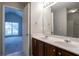 Bathroom with double sinks, large mirror, and view into bedroom through the doorway at 2482 Brittany Park Ln, Ellenwood, GA 30294