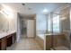Bathroom boasts a shower and soaking tub, tile flooring, and double sink vanity at 2482 Brittany Park Ln, Ellenwood, GA 30294