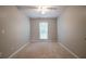 Carpeted bedroom with a ceiling fan, a window and neutral paint at 2482 Brittany Park Ln, Ellenwood, GA 30294