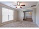 Spacious bedroom with plush carpeting, neutral walls, and a large window offering natural light at 2482 Brittany Park Ln, Ellenwood, GA 30294