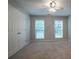 A carpeted bedroom with a ceiling fan and natural light from two windows at 2482 Brittany Park Ln, Ellenwood, GA 30294