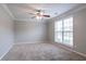 Spacious bedroom with plush carpeting, neutral walls, and a large window offering natural light at 2482 Brittany Park Ln, Ellenwood, GA 30294