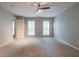 Spacious bedroom with neutral carpet, gray walls, two windows and ceiling fan for a comfortable retreat at 2482 Brittany Park Ln, Ellenwood, GA 30294