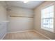Walk-in closet with adjustable shelving and a window providing natural light at 2482 Brittany Park Ln, Ellenwood, GA 30294