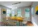 Stylish dining room with a modern light fixture and ample natural light at 2482 Brittany Park Ln, Ellenwood, GA 30294