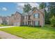 Charming two-story brick home with a well-manicured lawn and attached two-car garage in a suburban neighborhood at 2482 Brittany Park Ln, Ellenwood, GA 30294