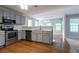 Modern kitchen featuring stainless steel appliances, gray cabinetry, and hardwood floors at 2482 Brittany Park Ln, Ellenwood, GA 30294