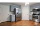 Modern kitchen featuring stainless steel appliances, gray cabinetry, and hardwood floors at 2482 Brittany Park Ln, Ellenwood, GA 30294