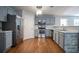 Modern kitchen featuring stainless steel appliances, gray cabinetry, and hardwood floors at 2482 Brittany Park Ln, Ellenwood, GA 30294