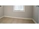 A functional laundry room with tile floor and a window, providing a bright and practical space at 2482 Brittany Park Ln, Ellenwood, GA 30294