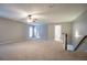 Spacious upstairs living area with ceiling fan and plenty of natural light at 2482 Brittany Park Ln, Ellenwood, GA 30294