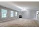 Cozy living room featuring a fireplace and large windows for natural light at 2482 Brittany Park Ln, Ellenwood, GA 30294