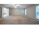 Spacious main bedroom with tray ceiling, carpet and natural light at 2482 Brittany Park Ln, Ellenwood, GA 30294