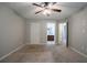 Spacious main bedroom with ceiling fan offers en-suite access to bathroom at 2482 Brittany Park Ln, Ellenwood, GA 30294
