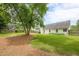 Large, fenced-in back yard with lush green grass and mature trees offers ample space for outdoor activities at 2870 Jay Oak Dr, Dacula, GA 30019