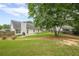 Spacious back yard with mature tree, wooden fence, and manicured lawn for relaxing or playing at 2870 Jay Oak Dr, Dacula, GA 30019