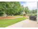 Lush backyard with mature trees, green grass, and play set at 2870 Jay Oak Dr, Dacula, GA 30019