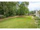 Picturesque backyard features a large lawn, play set, and mature trees, creating a serene outdoor space at 2870 Jay Oak Dr, Dacula, GA 30019