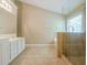 Bright bathroom featuring a double vanity, tiled floor, and a shower with glass enclosure at 2870 Jay Oak Dr, Dacula, GA 30019