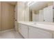 Bright bathroom with a large mirror, white vanity, and clean, white hexagon-tile flooring at 2870 Jay Oak Dr, Dacula, GA 30019