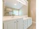 Well-lit bathroom with double sinks, white cabinetry, and a large mirror with modern lighting at 2870 Jay Oak Dr, Dacula, GA 30019