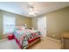 Cozy bedroom with bright colored bed, neutral walls and ceiling fan at 2870 Jay Oak Dr, Dacula, GA 30019