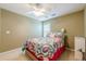 Bedroom featuring a bed with colorful patterned bedding and neutral walls with a ceiling fan at 2870 Jay Oak Dr, Dacula, GA 30019