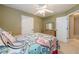 Bedroom with white trim, and colorful bed with closet and hall access at 2870 Jay Oak Dr, Dacula, GA 30019