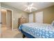 Comfortable bedroom featuring a ceiling fan, neutral walls, and stylish blue and white patterned bedding at 2870 Jay Oak Dr, Dacula, GA 30019