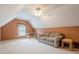 Spacious bonus room with carpet, a cozy couch, and a ceiling fan at 2870 Jay Oak Dr, Dacula, GA 30019
