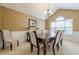 Dining room features wainscoting, chandelier, and seating for eight guests at 2870 Jay Oak Dr, Dacula, GA 30019
