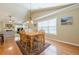 Dining room with wood table, bright windows and open view into living room at 2870 Jay Oak Dr, Dacula, GA 30019