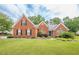 Charming brick home with a lush green lawn and manicured landscaping at 2870 Jay Oak Dr, Dacula, GA 30019