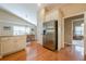 Kitchen with stainless steel refrigerator, granite countertops, and dining room access at 2870 Jay Oak Dr, Dacula, GA 30019