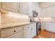 Well-lit kitchen boasts stone countertops, stainless steel appliances, and hardwood floors at 2870 Jay Oak Dr, Dacula, GA 30019
