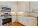 Charming kitchen features granite counters, stainless steel appliances, and white cabinetry at 2870 Jay Oak Dr, Dacula, GA 30019